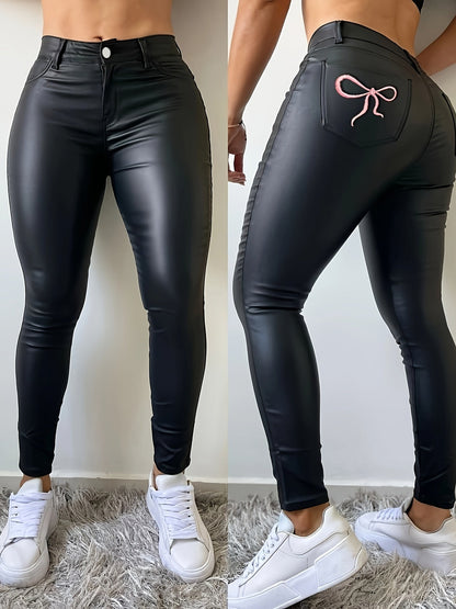 Damebukser i sort kunstlæder med skinny fit og sløjfedesign