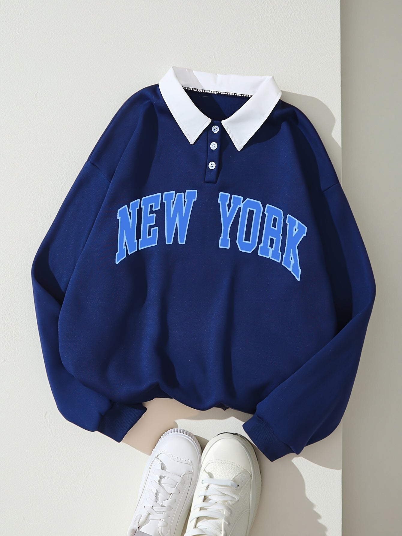 Mørkeblå pullover med New York-tekst, krave og knapper