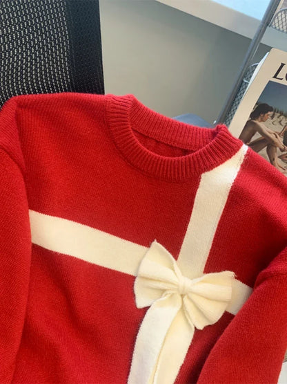 Roter Pullover mit weißem Band und Schleife